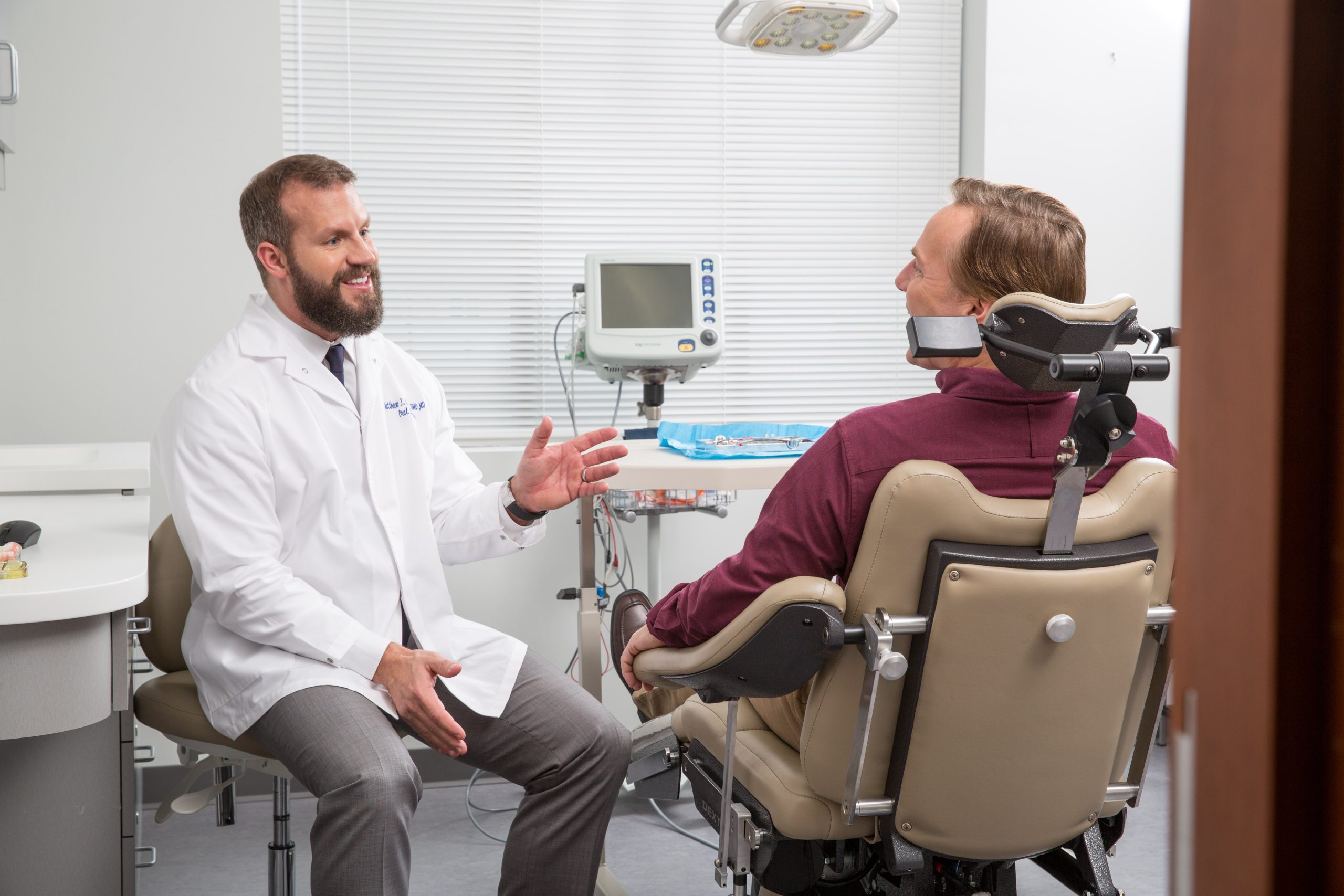 Dr. Karban speaking with a patient in a clinical room.