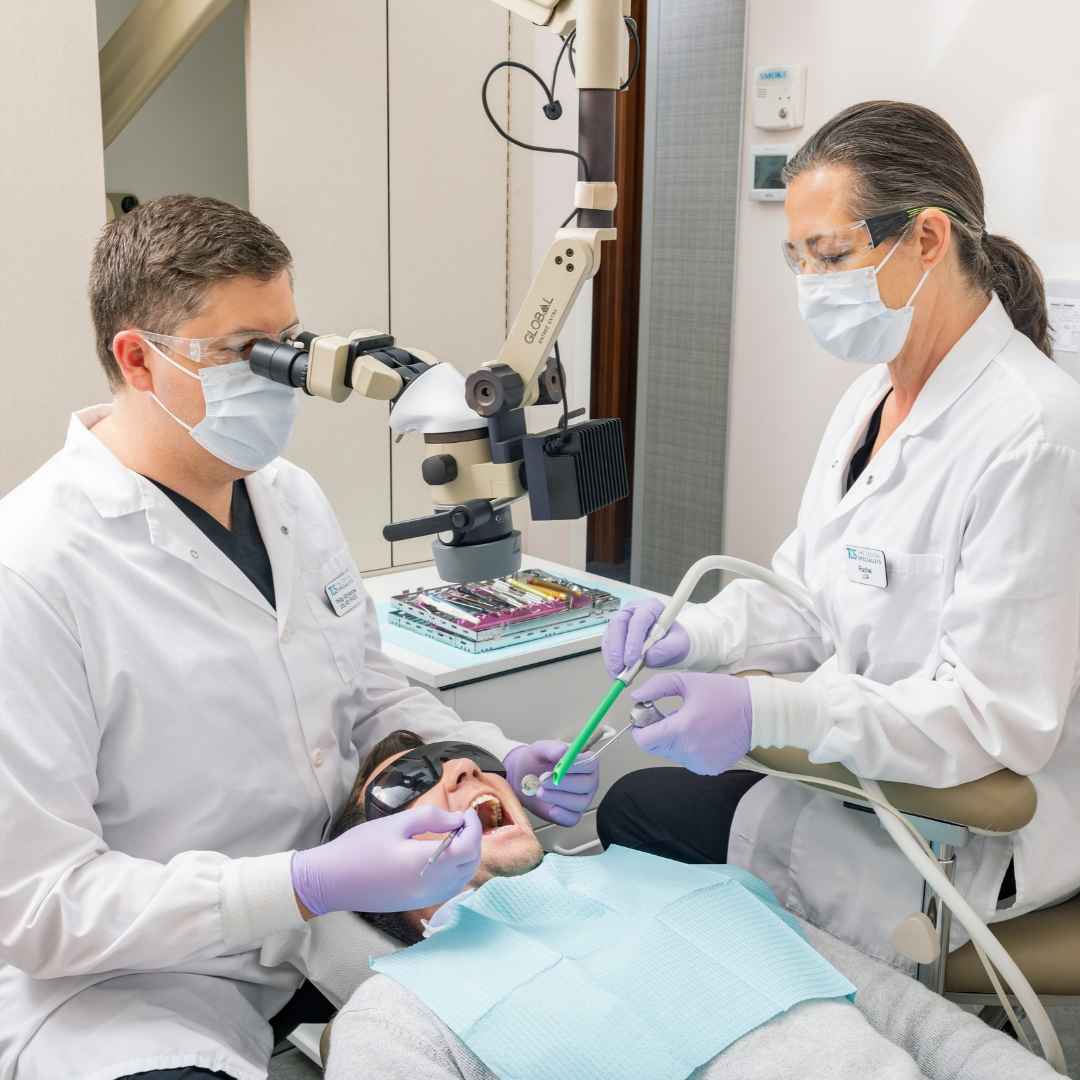 Dr. McKenzie and dental assistant performing an exam on a patient.